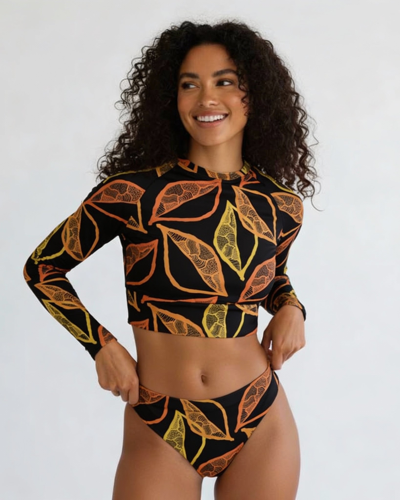 Gold Leaf long-sleeve crop top rashie worn with matching bottoms